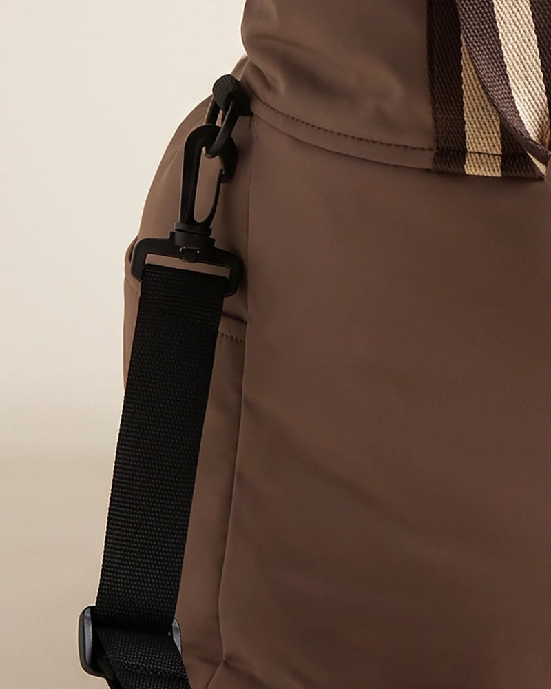 Close-up of the securing strap and clip on the Pip Dog Car Seat